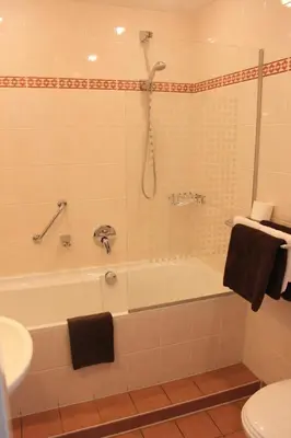 a bathroom with a tub and a toilet and a sink at Het Rechthuis in Uithoorn