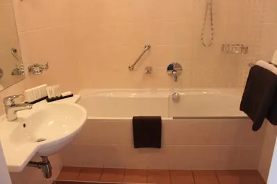 a bathroom with a sink and a bath tub next to a sink at Het Rechthuis in Uithoorn