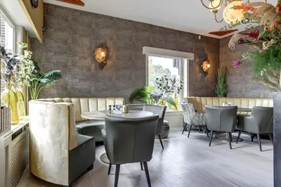 a dining room with a table and chairs at Het Rechthuis in Uithoorn