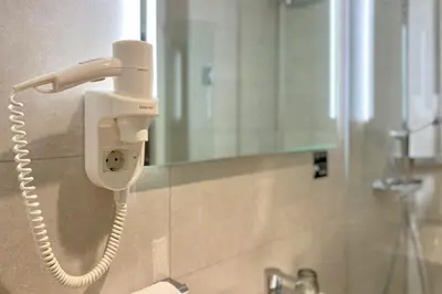 a phone is on a wall in a bathroom at XO Hotels City Centre in Amsterdam