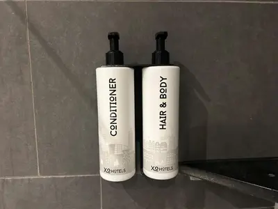 two bottles of sunscreen sitting next to each other at XO Hotels City Centre in Amsterdam