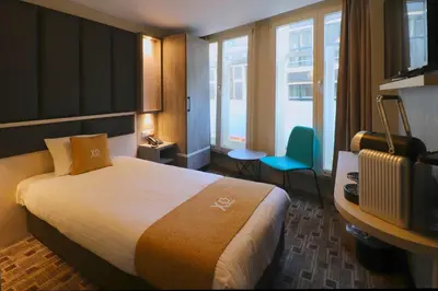 a hotel room with a bed and a television at XO Hotels City Centre in Amsterdam