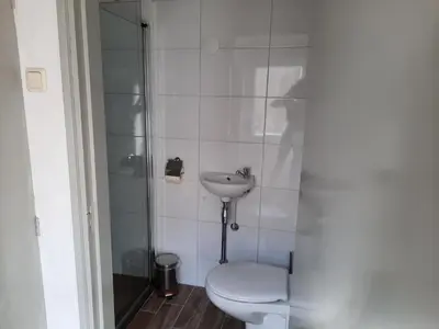 a bathroom with a toilet and a sink at Zomerhuis Visser Egmond in Egmond aan Zee