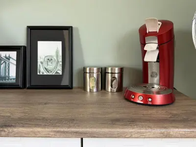 a counter with pictures and a red coffee maker on it at Loft met veel zonlicht in Breukelen