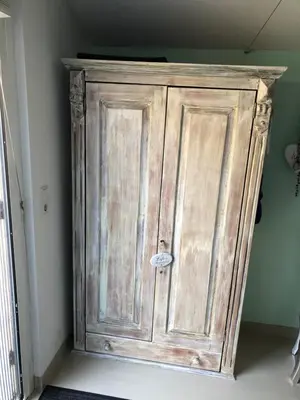 a wooden cabinet in the corner of a room at Romantisch Tiny Gardenhouse in beautiful garden in Zandvoort