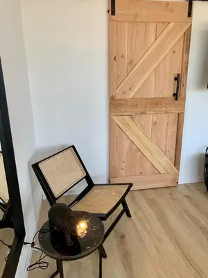 a room with a chair and a table and a door at Amsterdam Beach Apartment 76 in Zandvoort