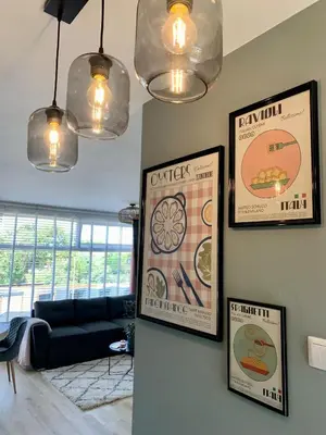 a living room with posters on the wall at Amsterdam Beach Apartment 76 in Zandvoort