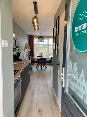 a kitchen and dining room with a dining table at Amsterdam Beach Apartment 76 in Zandvoort