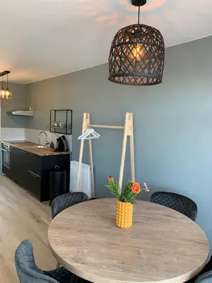a kitchen and dining room with a table and chairs at Amsterdam Beach Apartment 76 in Zandvoort