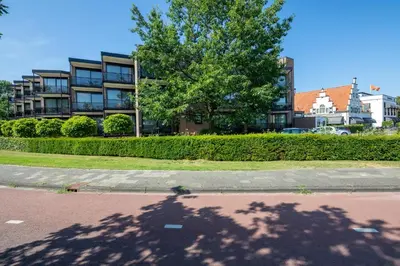 a shadow of a tree in front of a building at Van der Valk Hotel Leiden in Leiden