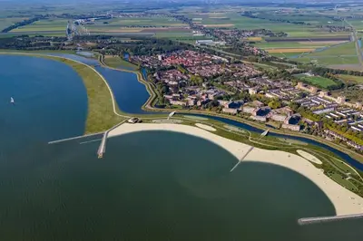 an aerial view of the shoreline of a lake at Cozy chalet near Amsterdam at Camping Venhop in Berkhout