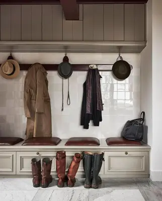 a bench with boots and coats and pots and pans at Landgoed Huis te Jaarsveld in Jaarsveld
