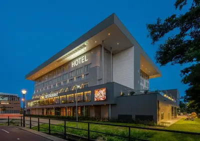 a hotel building with a sign in front of it at Van der Valk Hotel Haarlem in Haarlem