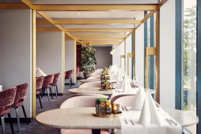 a row of tables and chairs in a restaurant at Van der Valk Hotel Haarlem in Haarlem