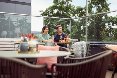 two people sitting at a table in a restaurant at Van der Valk Hotel Haarlem in Haarlem