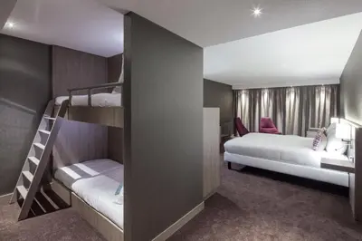 a bunk bed room with two bunk beds and a bedroom at Van der Valk Hotel Haarlem in Haarlem