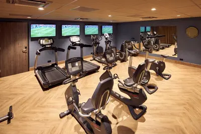 a gym with a row of exercise bikes in a room at Van der Valk Hotel Haarlem in Haarlem