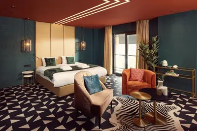 a hotel room with a bed and a chair at Van der Valk Hotel Breukelen in Breukelen