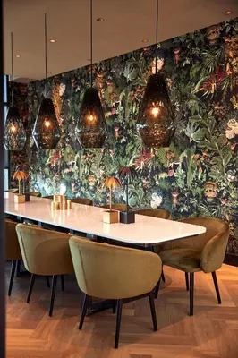 a dining room with a table and chairs and a floral wall at Van der Valk Hotel Breukelen in Breukelen