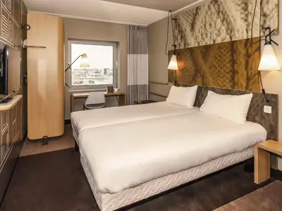 a hotel room with a large bed and a window at ibis Amsterdam City West in Amsterdam