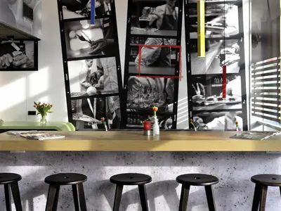 a counter with stools in a restaurant with a counter top at ibis Amsterdam City West in Amsterdam