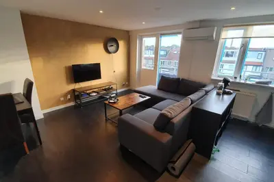 a living room with a couch and a television at Luminous appartment - Juliana Park free parking in Utrecht