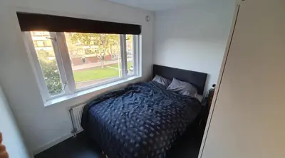 a bedroom with a bed and a window at Luminous appartment - Juliana Park free parking in Utrecht