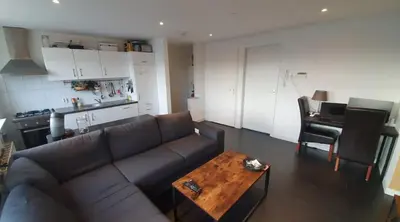 a living room with a couch and a table at Luminous appartment - Juliana Park free parking in Utrecht