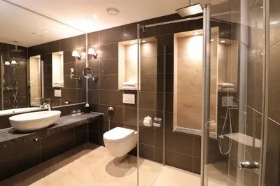 a bathroom with a toilet and a sink and a shower at XO Hotels Couture in Amsterdam