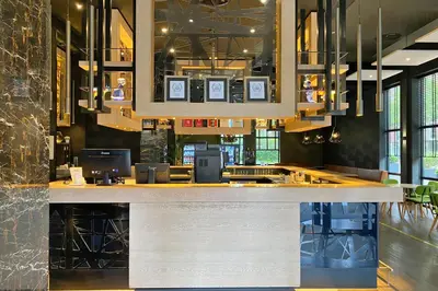 a bar in a restaurant with tables and chairs at XO Hotels Couture in Amsterdam