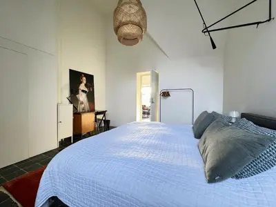 a bedroom with a large white bed in it at Apartment in former Bathhouse in Amsterdam