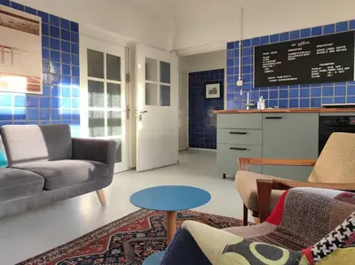 a living room with a couch and a table at Apartment in former Bathhouse in Amsterdam