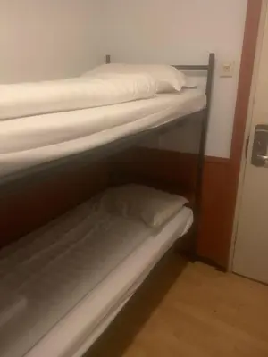 two bunk beds in a small room with a closet at Hotel Continental Amsterdam in Amsterdam
