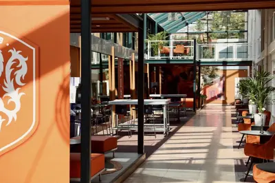 a restaurant with tables and chairs in a building at Fletcher Hotel-Restaurant Oud London in Zeist