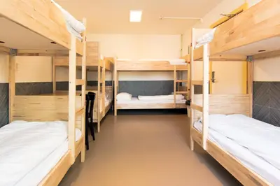 a room with three bunk beds in a hostel at Hotel The Globe in Amsterdam