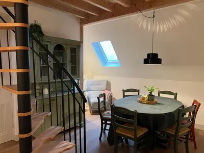 a dining room with a blue table and chairs at Inn Het Nest in Amsterdam
