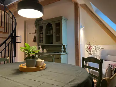 a dining room with a table with a plant on it at Inn Het Nest in Amsterdam