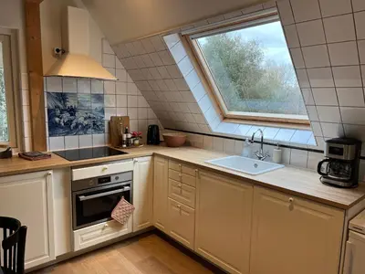 a kitchen with a sink and a window at Inn Het Nest in Amsterdam