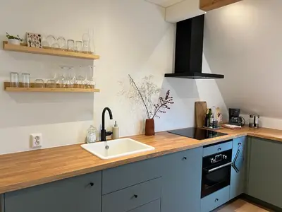 a kitchen with a sink and a counter top at Inn Het Nest in Amsterdam