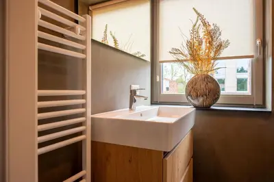 a bathroom with a sink and a window at Parc La Dune Dutch Lodge in Warmenhuizen