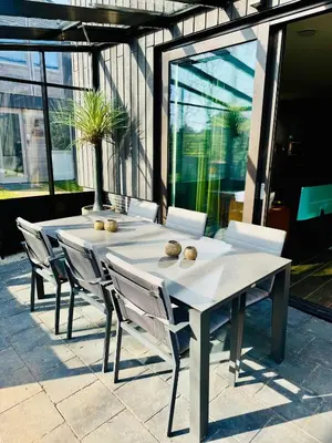 a white table and chairs in front of a building at Parc La Dune Marrakesh Lodge in Warmenhuizen