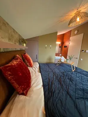a bedroom with a large bed with red pillows at Parc La Dune Marrakesh Lodge in Warmenhuizen