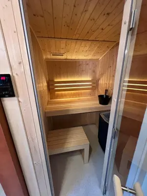a sauna with wooden walls and a wooden ceiling at Parc La Dune Marrakesh Lodge in Warmenhuizen