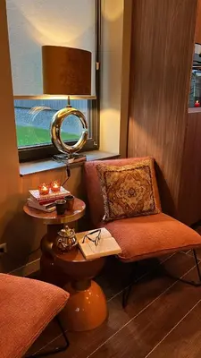 a room with a chair and a table and a mirror at Parc La Dune Marrakesh Lodge in Warmenhuizen