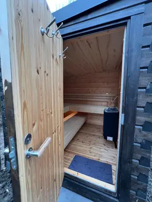 a wooden sauna with a door in the middle at Parc La Dune South Africa Lodge in Warmenhuizen