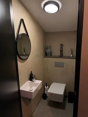 a bathroom with a sink and a mirror and a toilet at Parc La Dune South Africa Lodge in Warmenhuizen