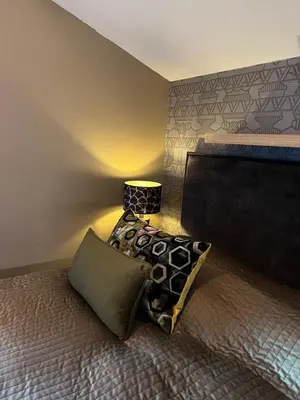 a bedroom with a bed with two pillows on it at Parc La Dune South Africa Lodge in Warmenhuizen