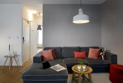 a living room with a blue couch and a table at Haarlem Hotel Suites in Haarlem