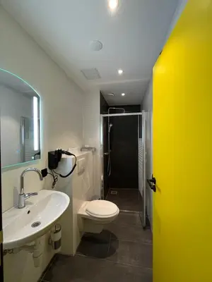 a bathroom with a toilet and a sink and a shower at Heart of Amsterdam Hostel in Amsterdam