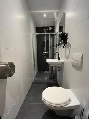 a small bathroom with a toilet and a sink at Heart of Amsterdam Hostel in Amsterdam